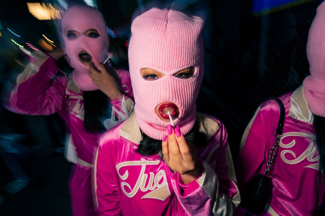 5 - Pink is the color of the night for this mask-wearing trio of revelers in Tokyo.