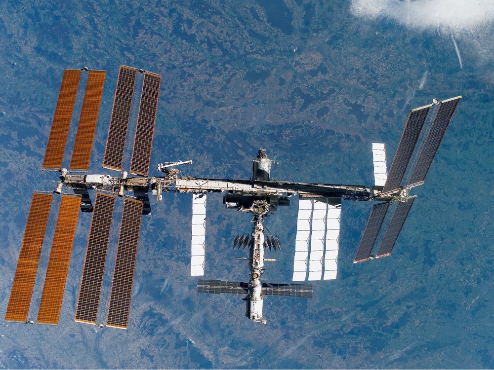 An aerial view of the International Space Station, with Earth visible below