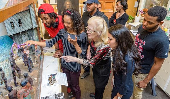 Matthew Fields (left) assessing a diorama at the University of Delaware in 2017
