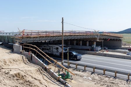 The overpass is expected to be completed in December 2025, with landscaping work to be finished in 2026.