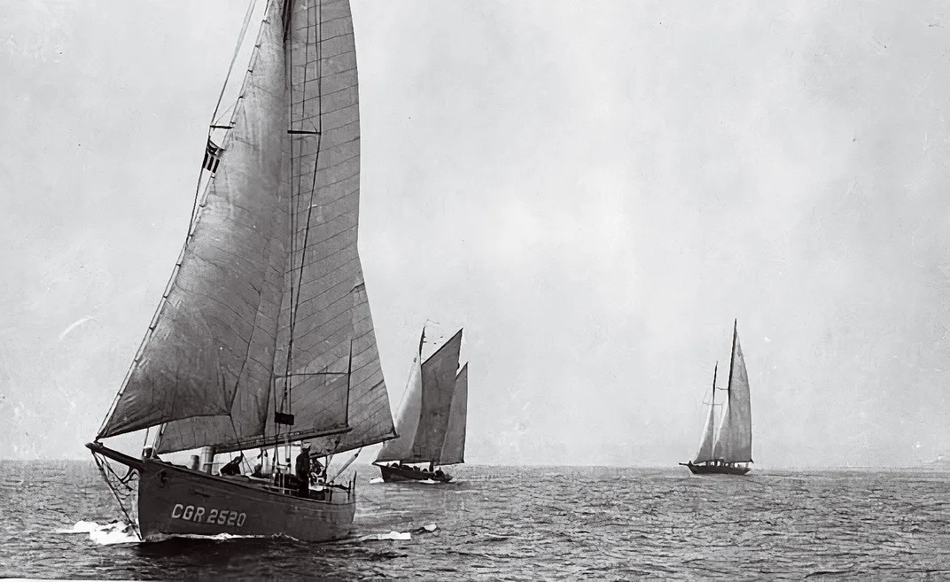three sailboats at sea