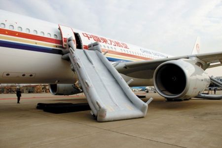 From the door and emergency exits of a China Eastern Airlines Airbus A330-300, evacuation slides are deployed. The fully inflated slide is 31 feet long.