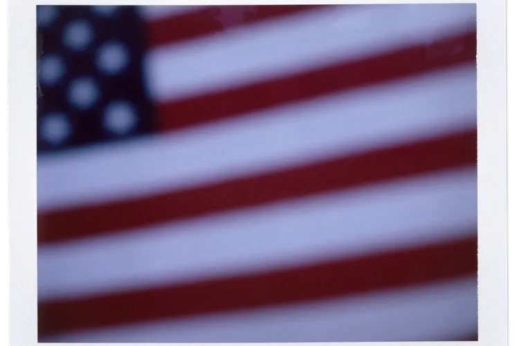 An American flag sits atop a gravestone in the cemetery of Oak Mountain Baptist Church in Shelby County, Alabama.