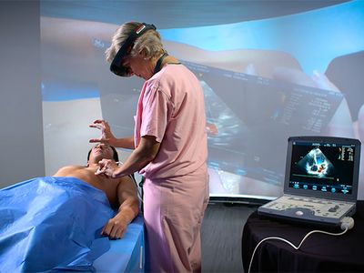Trauma surgeon Sarah Murthi tests an AR headset prototype, which uses a Microsoft HoloLens and custom software with an ultrasound, on a volunteer "patient."
