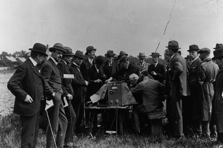 A group waits for news out of Versailles by a wireless Marconi radio, June 1, 1919.