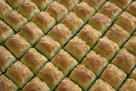 Baklava&nbsp;consists of fine layers of pastry dough, often filled with nuts and sweetened with syrup or honey.