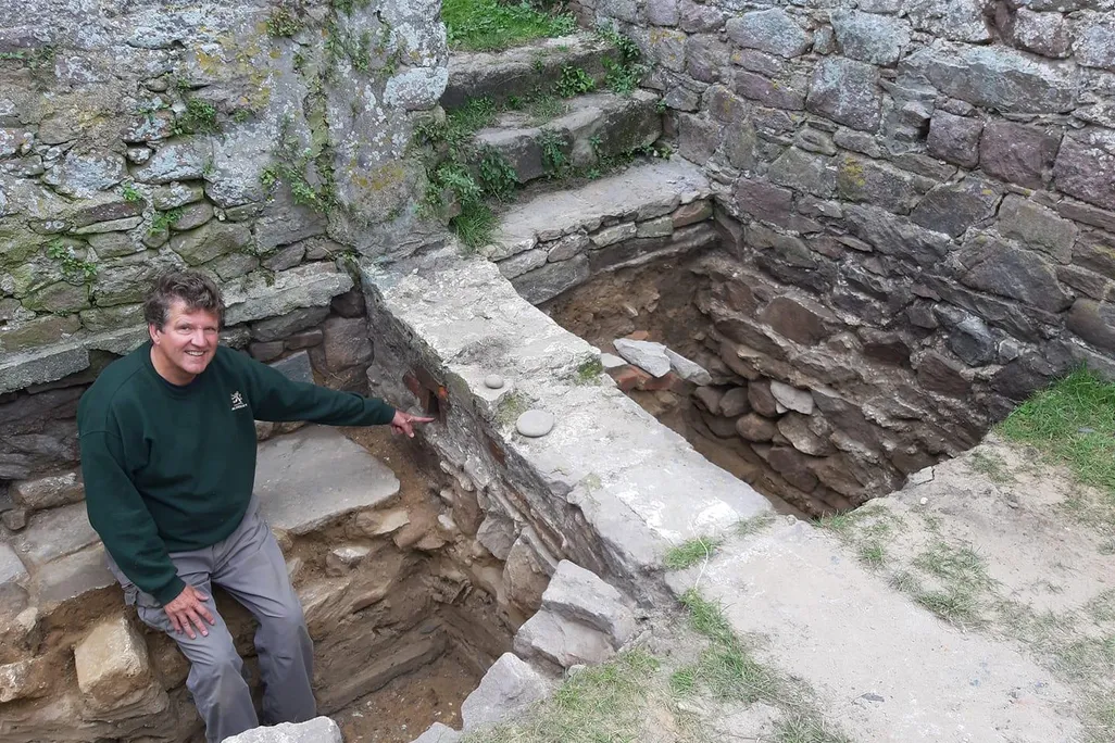 A researcher points to drainage structures at the Nunnery