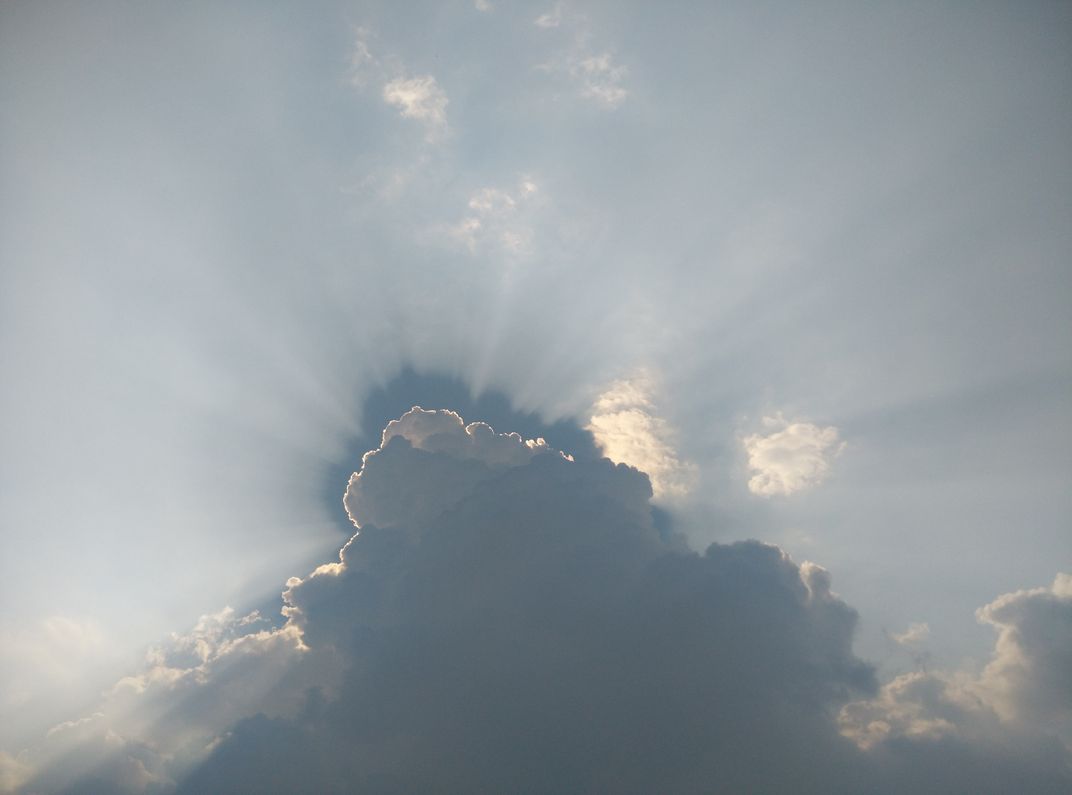 Sun rays piercing the outlines of clouds | Smithsonian Photo Contest ...