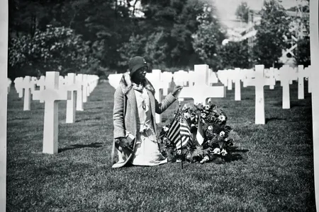 Between 1930 and 1933, the U.S. government funded segregated trips to American military cemeteries in Europe for mothers and widows of fallen soldiers. This Gold Star Pilgrim is visiting a soldier’s grave at Suresnes American Cemetery, west of Paris. 