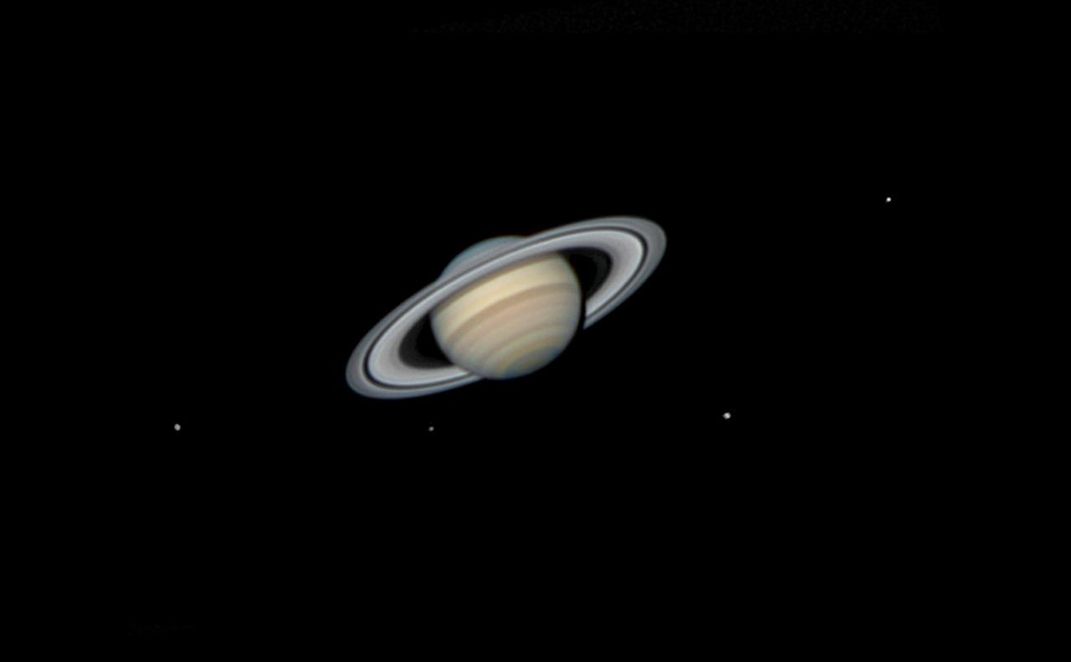 An image of planet Saturn surrounded by its moons