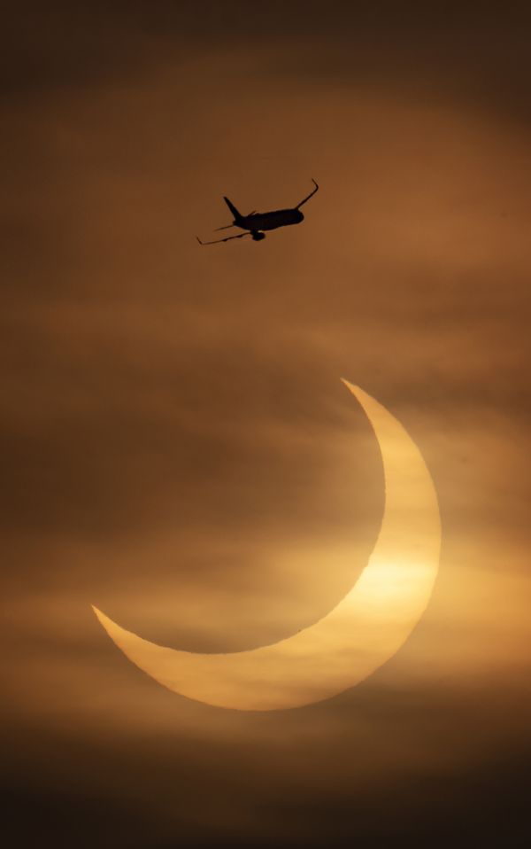 Plane Over Partial Solar Eclipse thumbnail