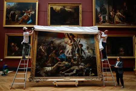 Louvre employees rehung Eugene Delacroix's 1830 oil painting&nbsp;Liberty Leading the People&nbsp;on Thursday after a six-month restoration.