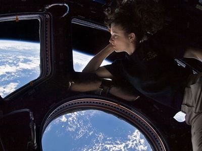 Astronaut Tracy Caldwell Dyson in the ISS’ Cupola, where a micrometeorite hit the window last year.