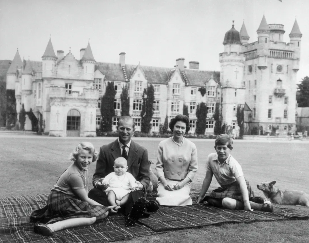 Black and white photo of royal family in front of castle