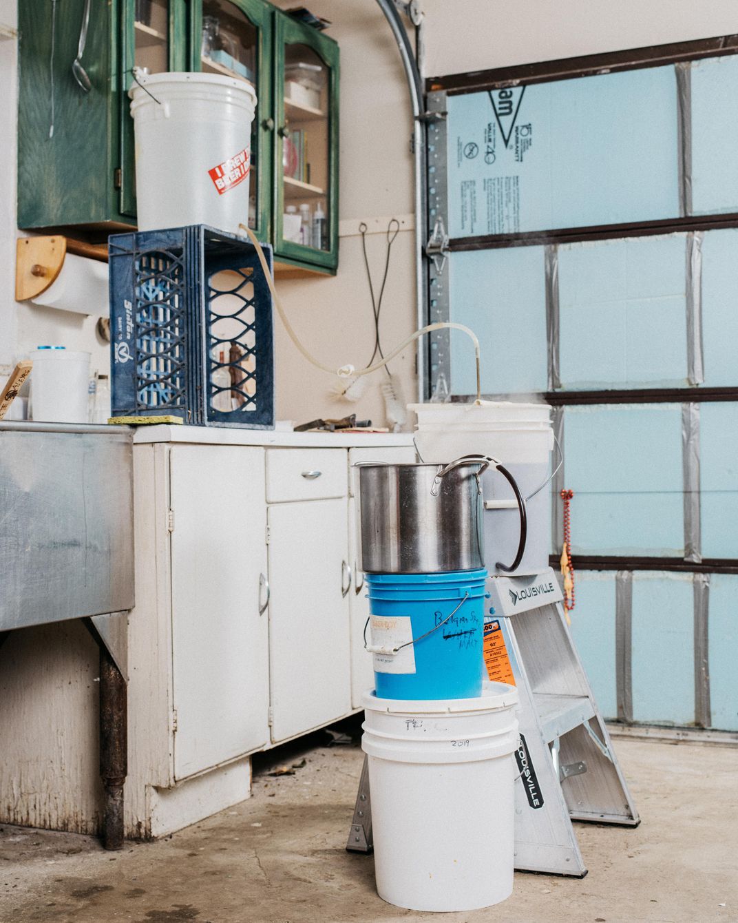 Papazian's homebrewing setup, with sink and buckets