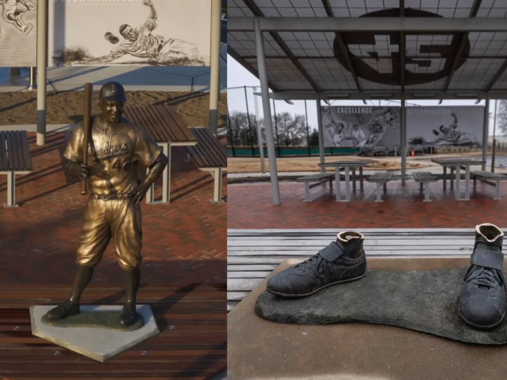 Side by side of a bronze statue of Jackie Robinson and a pair of bronze statue feet