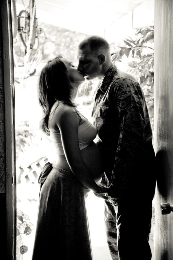 Expecting wife kissing her soldier good-bye thumbnail