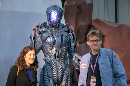 Awesome Con provided an opportunity for science fiction and real-life science to play off of one another. The Robot from Netflix's Lost in Space reboot (center) illustrates the former, while the NASA jacket of the con attendee on the right nods to the latter.