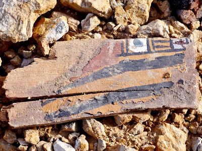 A painted wooden coffin beside a looted tomb in the Abu Sir al Malaq necropolis in Bani Suef, Egypt.