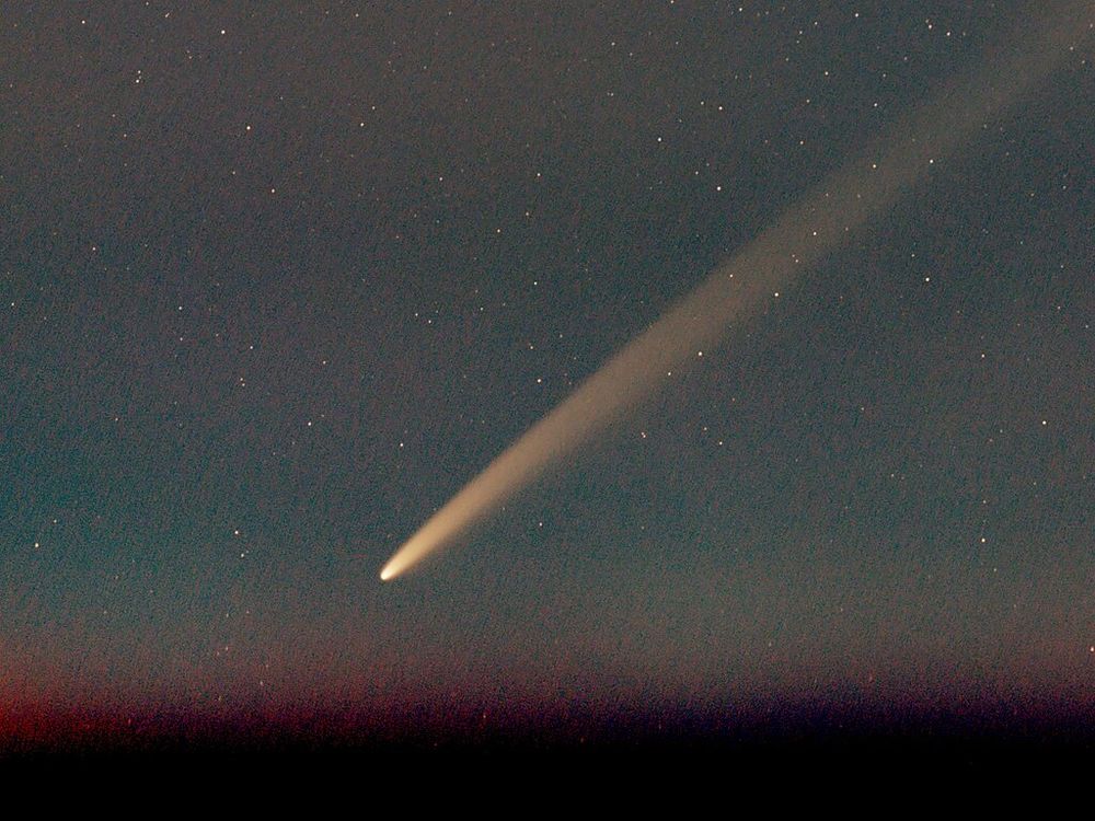 Bright comet in a dark sky.