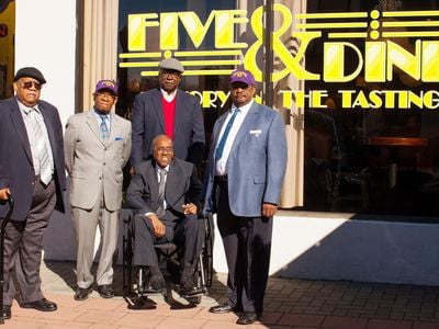 Friendship Nine members Clarence Graham, Willie Thomas Massey, David Williamson Jr., James F. Wells and Willie E. McCleod (L-R) stand in front of the renamed Five & Dine diner in Rock Hill, South Carolina, on December 17, 2014