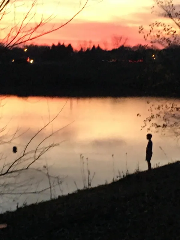 Patience of a boy longing for his ball to return from the lake’s waters thumbnail