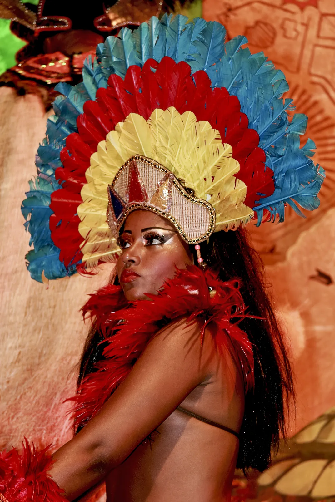A woman wears a bright colorful headdress