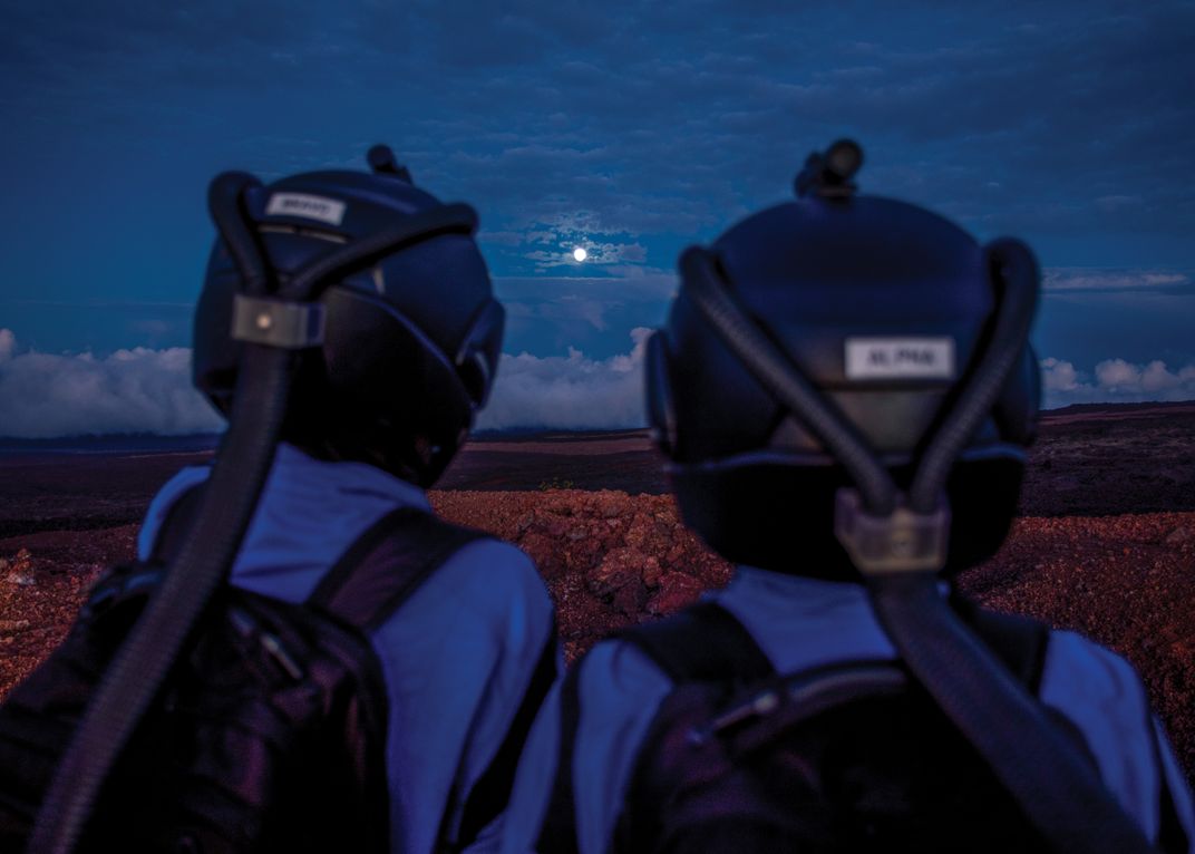 two people looking up at the moon