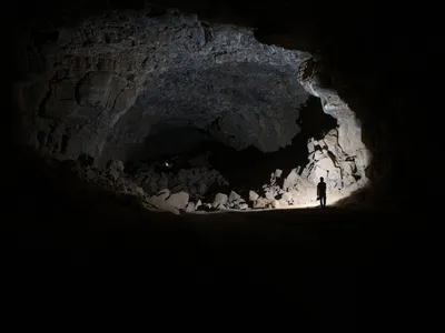A researcher explores the depths of Umm Jirsan.