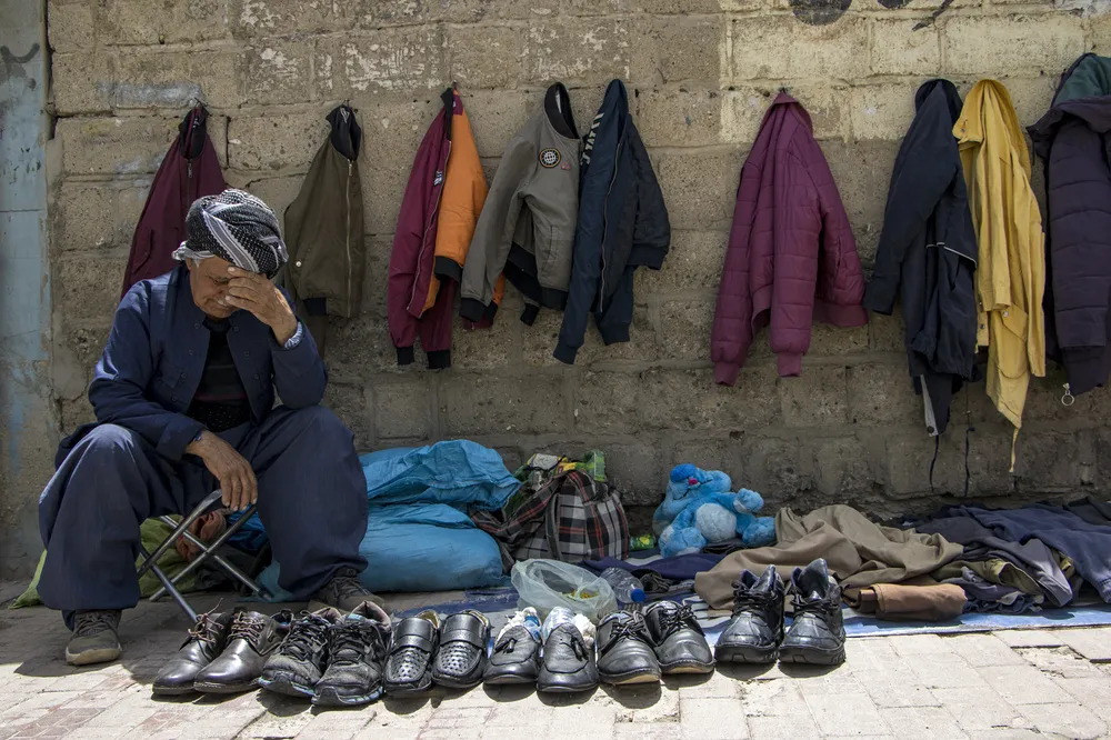 On the street vendors, everyone has something for sale. From old things to prayer beads, shoes and jackets. On this day, the old man had nothing to sell and was sad.