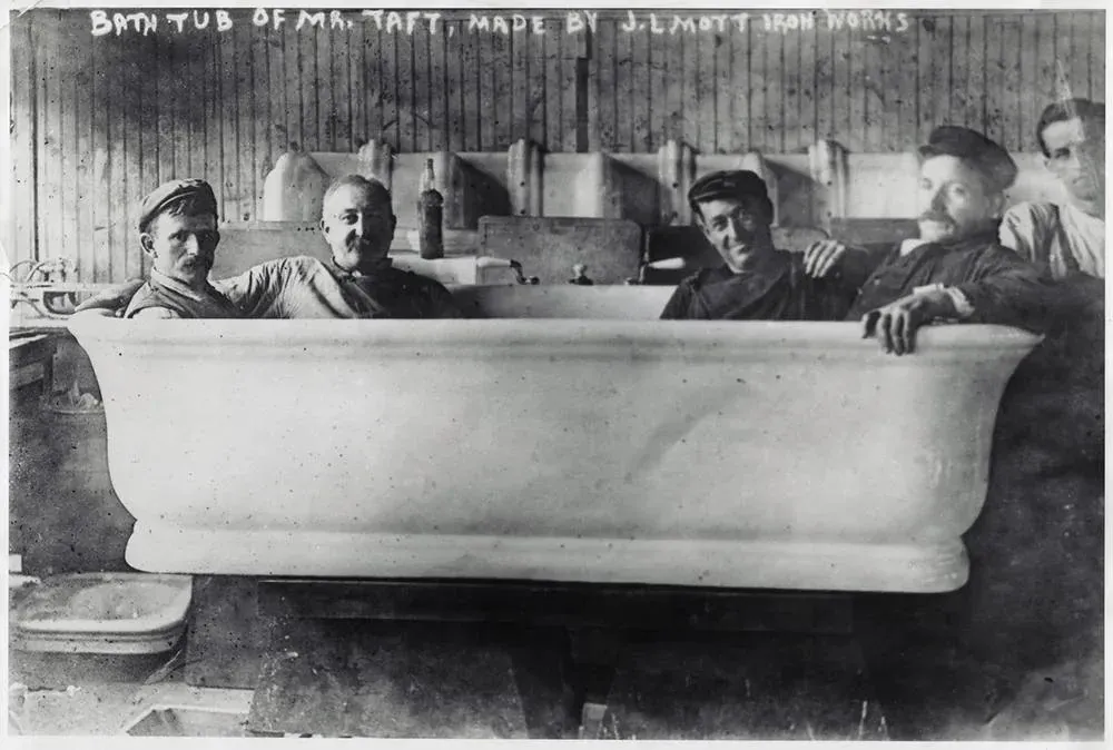 A 1909 photo of four men in a bathtub built for Taft